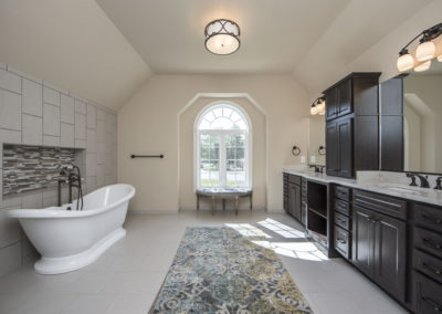 A large bathroom with luxury bathtub and double sink areas for both parties.